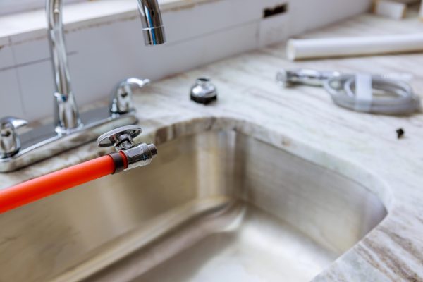 kitchen sink install Concept, Creative Photo About Plumber installing sink in kitchen interior.